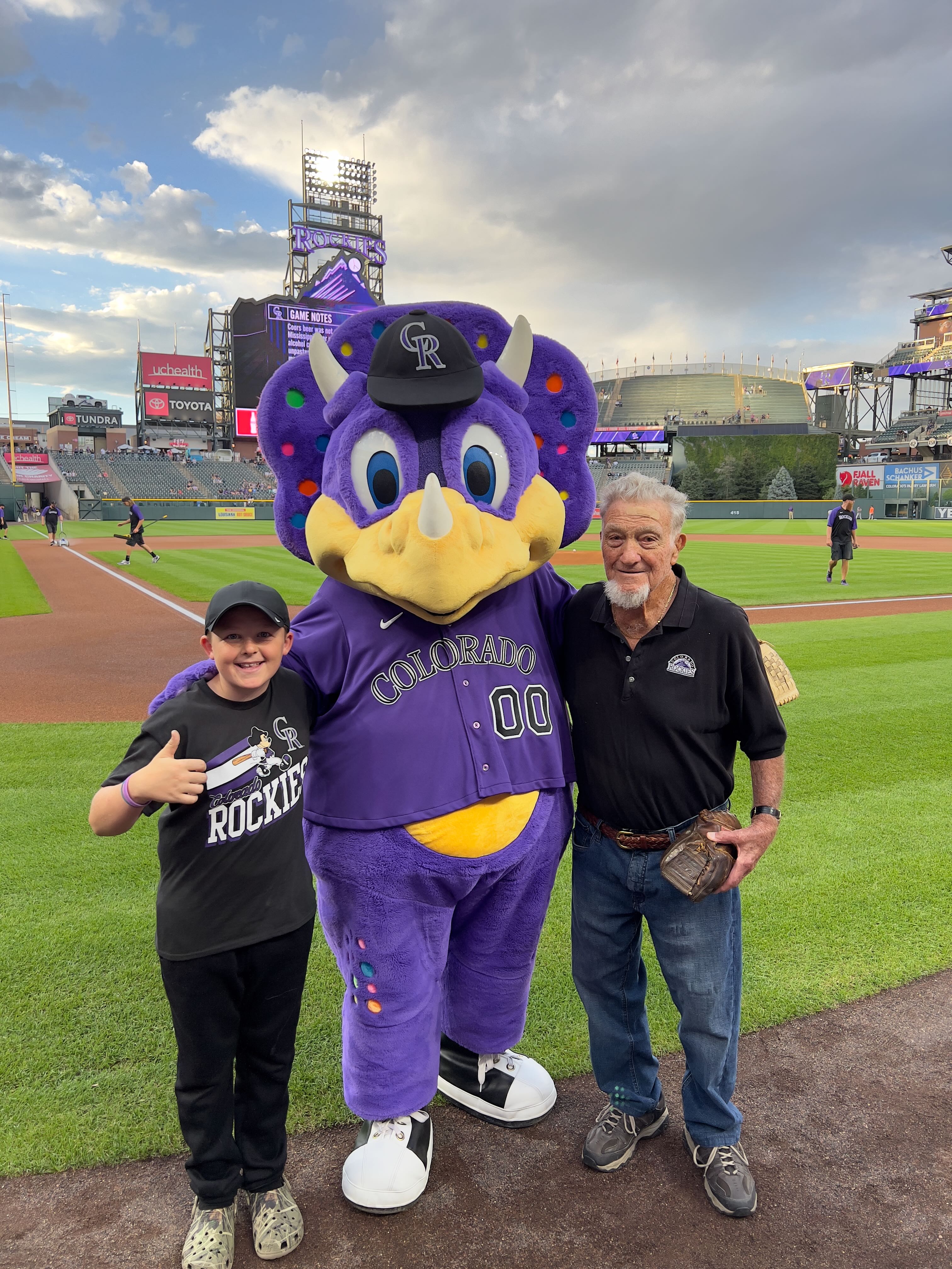 Joe Rossi throws the first pitch at a Rockies game